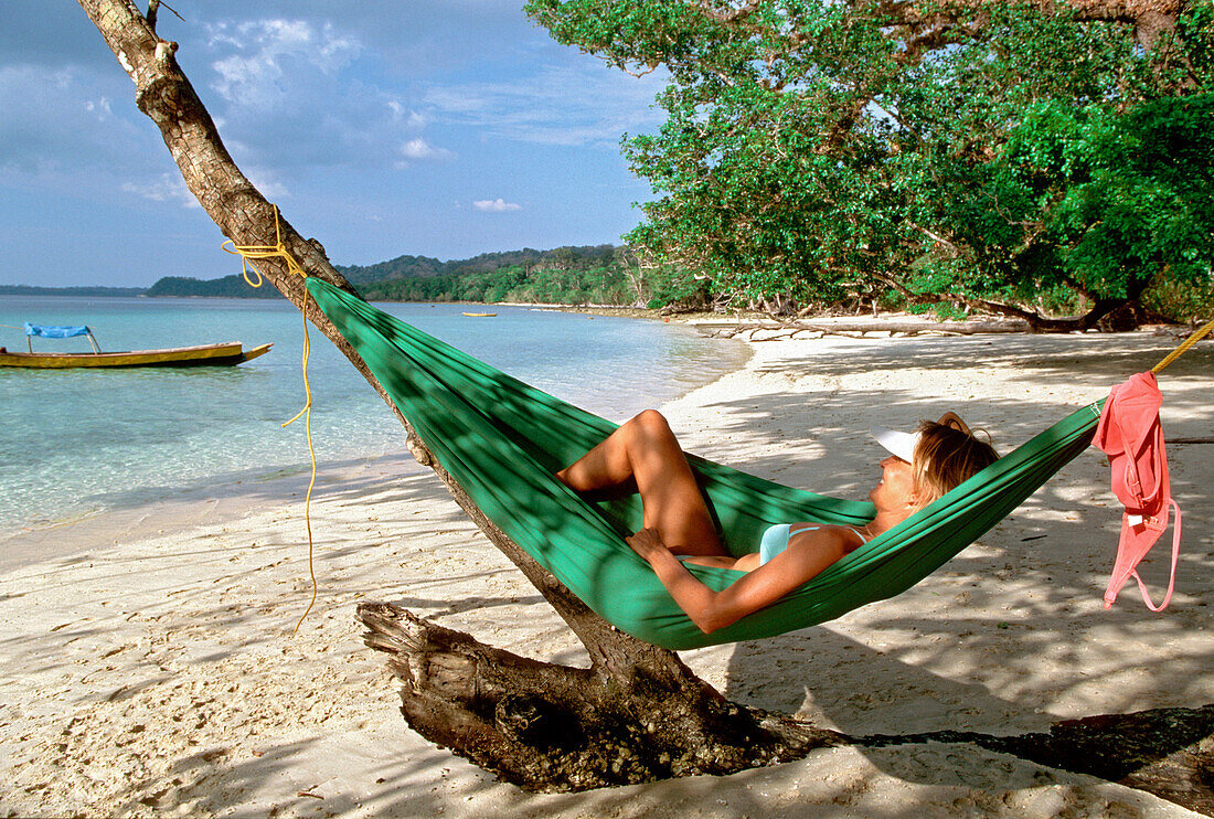 Woman in a hammock on Elephant Beach, Havelock Islands, Andaman Islands, India