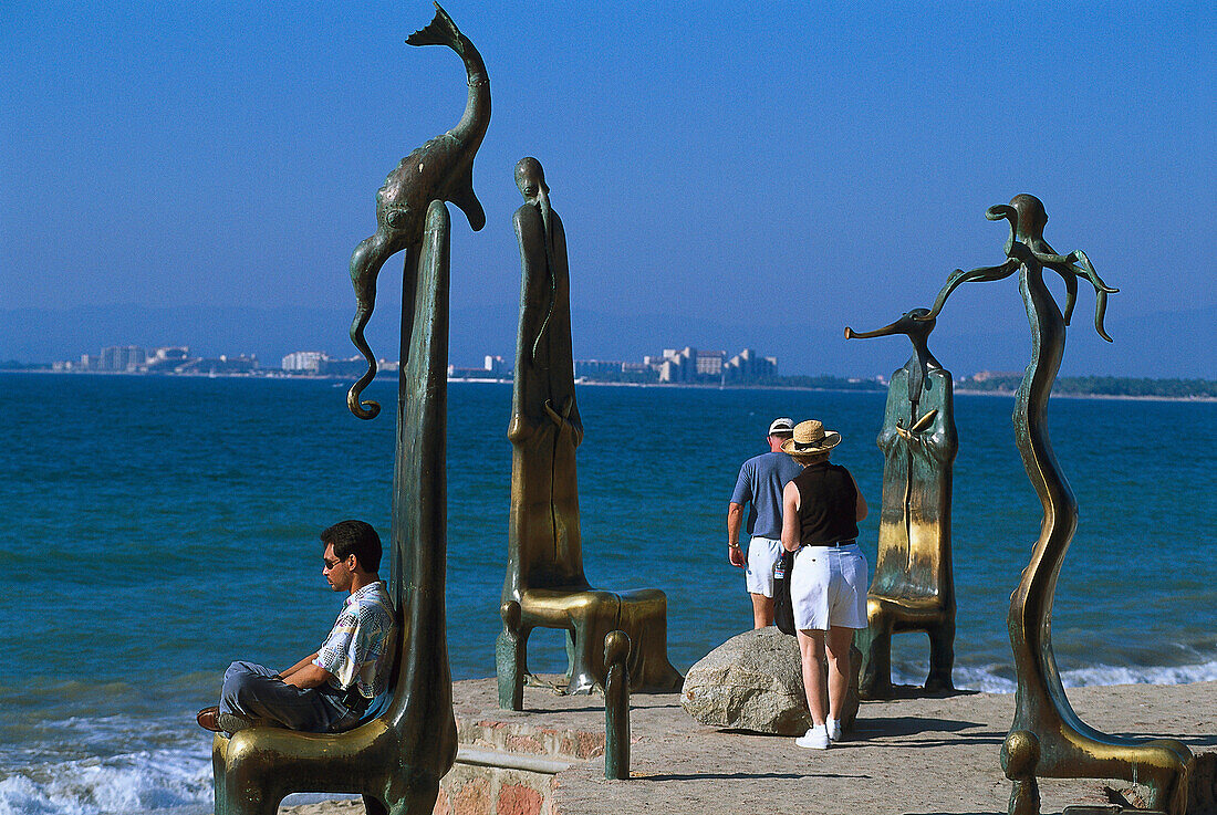 Sculptures and people on the waterfront in the sunlight, Malecon, Puerto Vallarta, Jalisco, Mexico, America