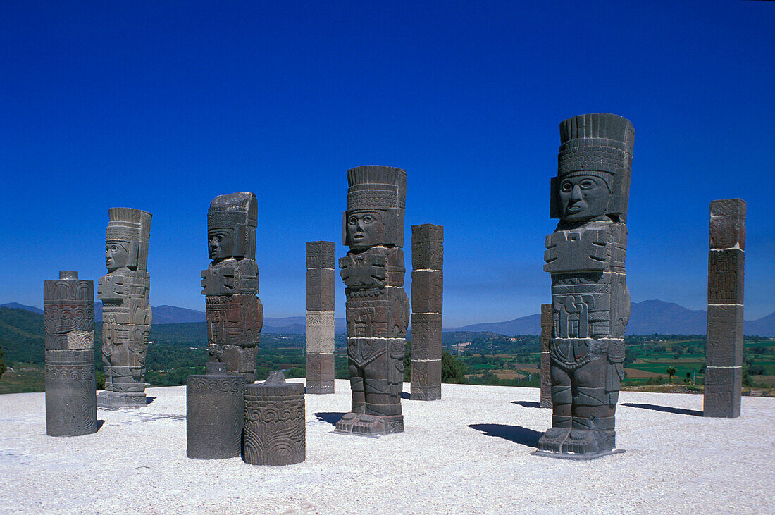 Sculptures under blue sky, Atlases on pyramid B, Tula, Hidalgo, Mexico, America