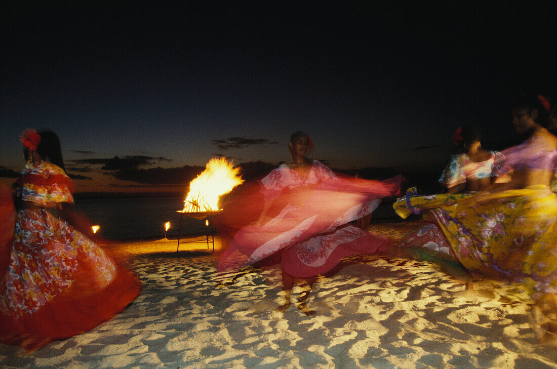 Women dancing Sega dance on the beach, Hotel Trou aux Biches, Mauritius, Africa