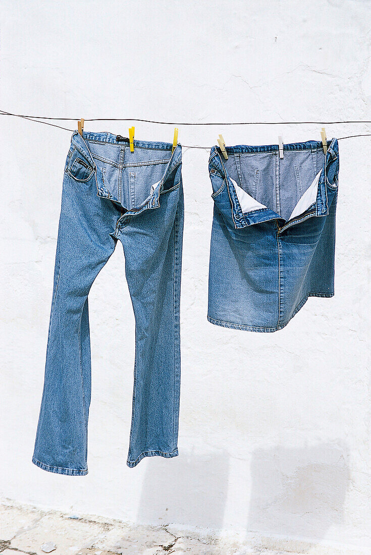 Jeans trousers and jeans skirt drying on clothesline, Bavaria, Germany