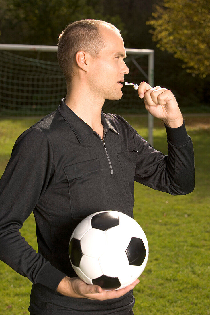 Referee blowing whistle