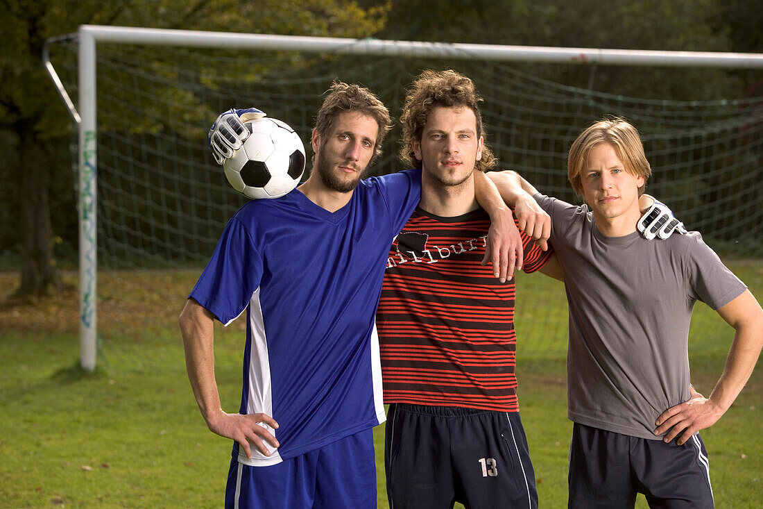 Three young male soccer players