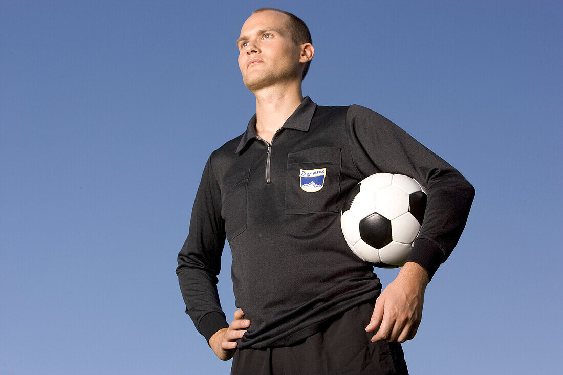 Referee with soccer ball in hands