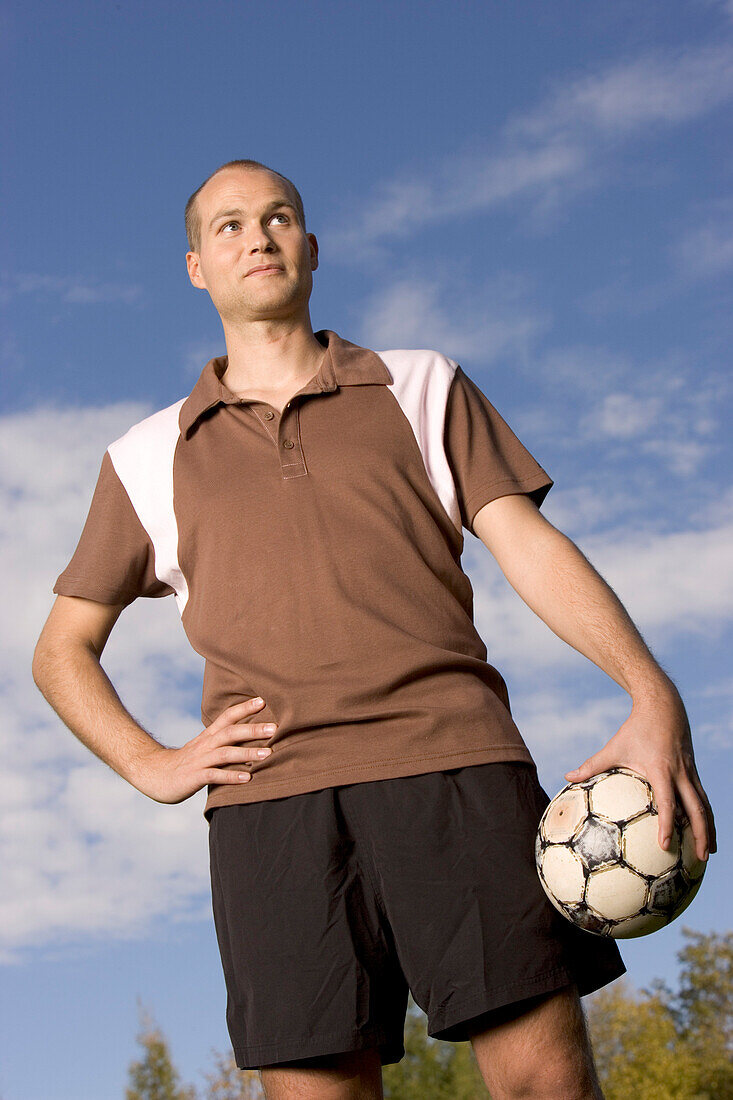 Portrait of a young soccer player, eyes looking in sky