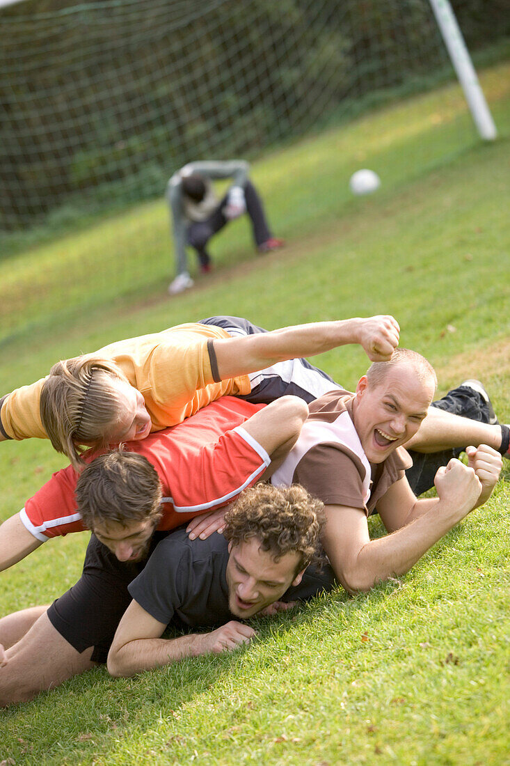 Young male soccer players jubilating