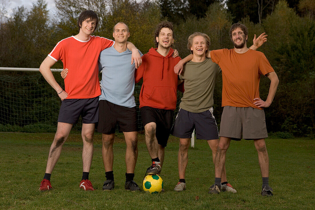 Five young male soccer players in a row