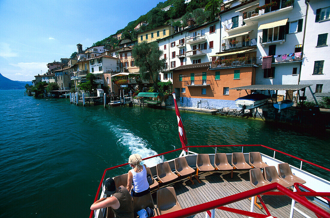 Gandria , People on excursion boat leaving Gandria, Lake of Lugano, Tessin, Switzerland