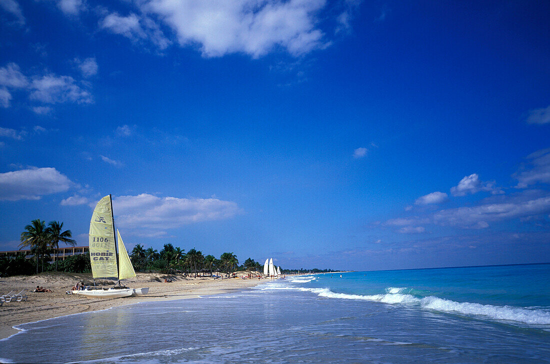 People and sailing boat on the beach, Playas del Este, Cuba, Caribbean, America
