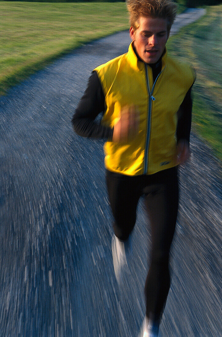 A jogger running on a gravel walk, Stubaital Valley, Tyrol, Austria