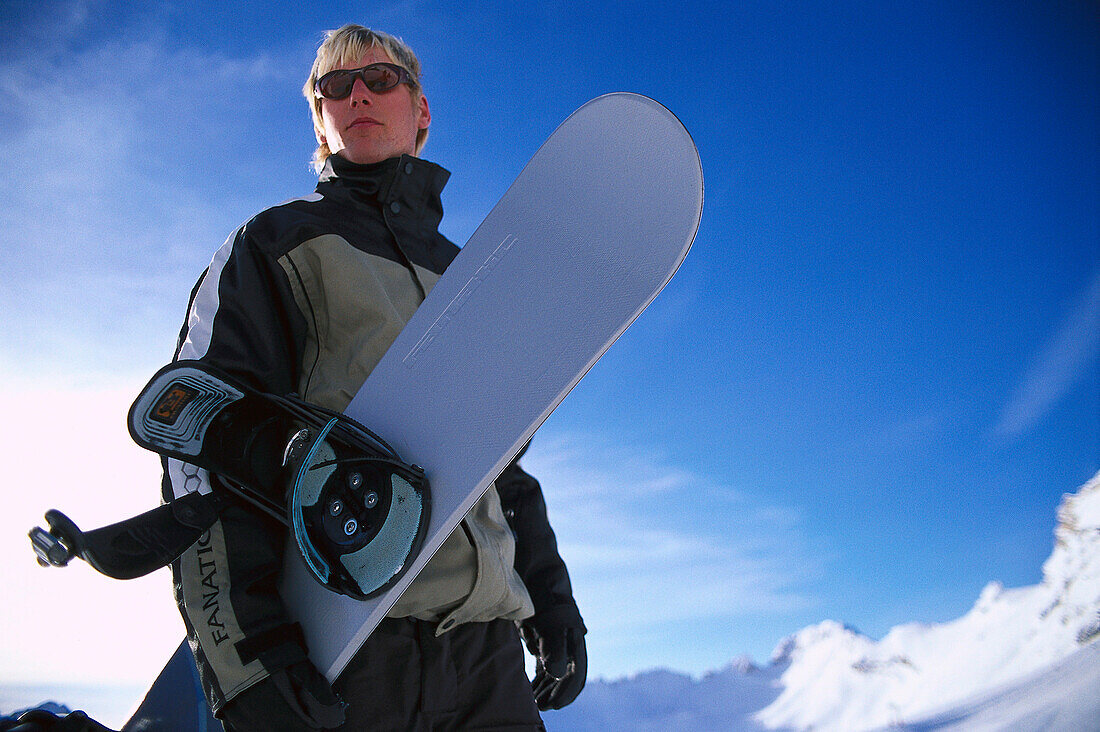 Snowboarder with his snowboard, Zugspitze, Bavaria, Germany