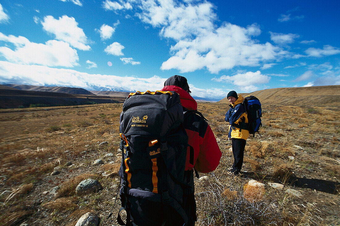 Two hikers in barren landscape, Kyrgyzstan, Asia