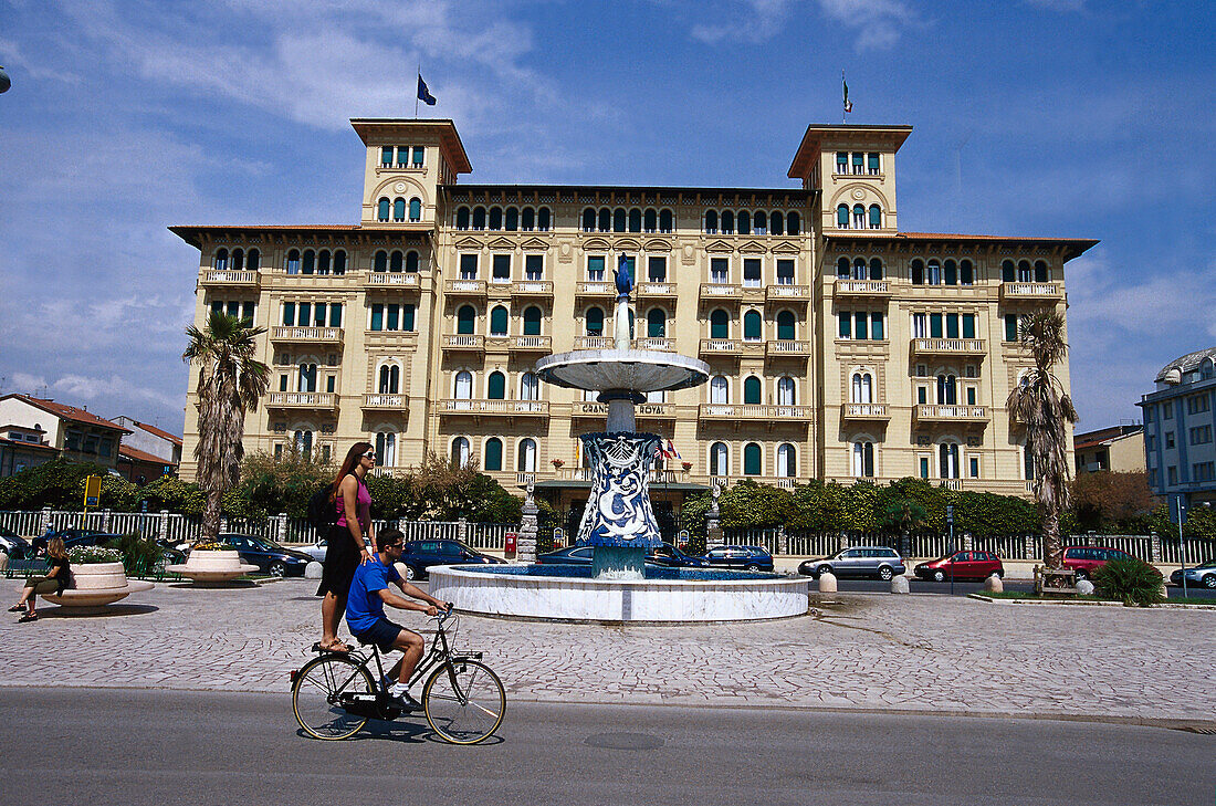 Cyclist and fountain in front of Gran Hotel Royal, Viareggio, Tuscany, Italy, Europe