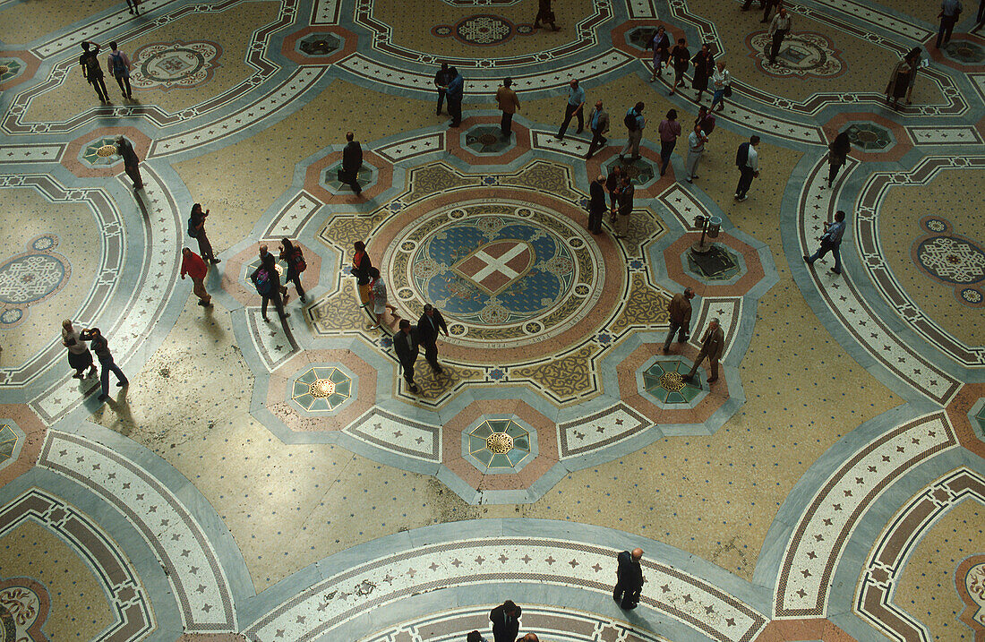 People in Galleria Vittorio Emanuele II, floor mosaic, Milan, Italy