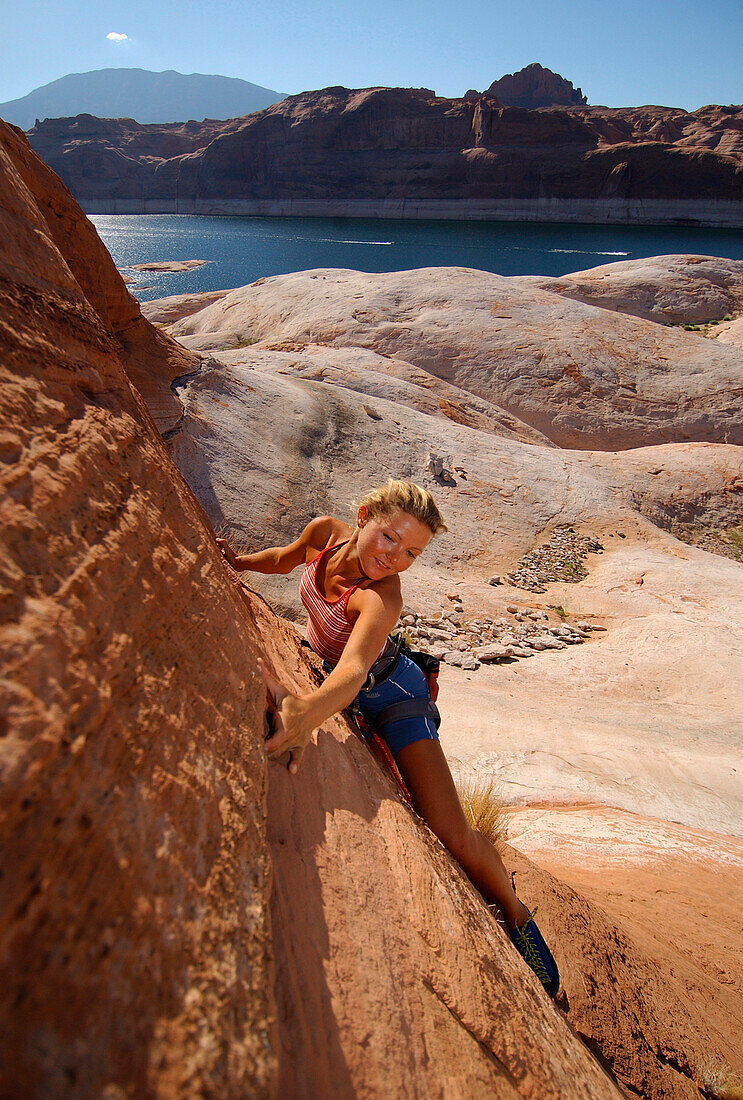 Woman climbing at Lake Powell, Arizona, USA