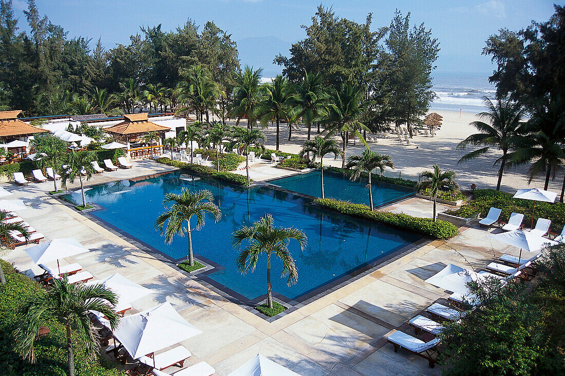 Schwimmbad mit Palmen im Sonnenlicht, Furama Resort, Danang, Vietnam, Asien