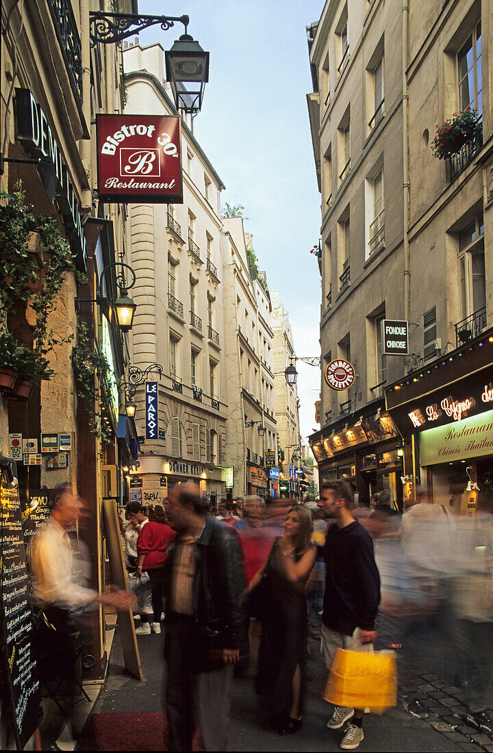 people in street scene in Saint Michel, Paris, France