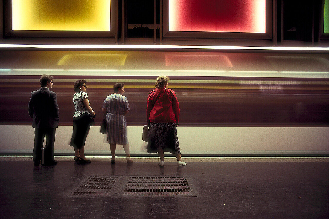 People waiting at a metro station, metro train in motion, Metro, Paris, France