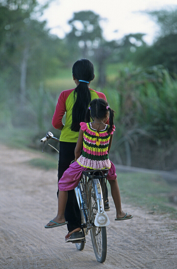 two girls on bicycle, Cambodia, Asia