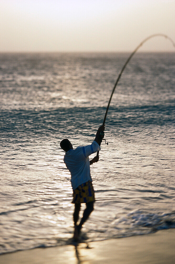 Man is fishing at the beach of Sáo Pedro, Sáo Vicente, Cape Verde, Africa