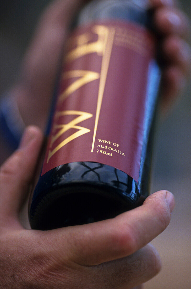 Australian red wine bottle in hand, Wandin Valley Vineyard, Asutralia