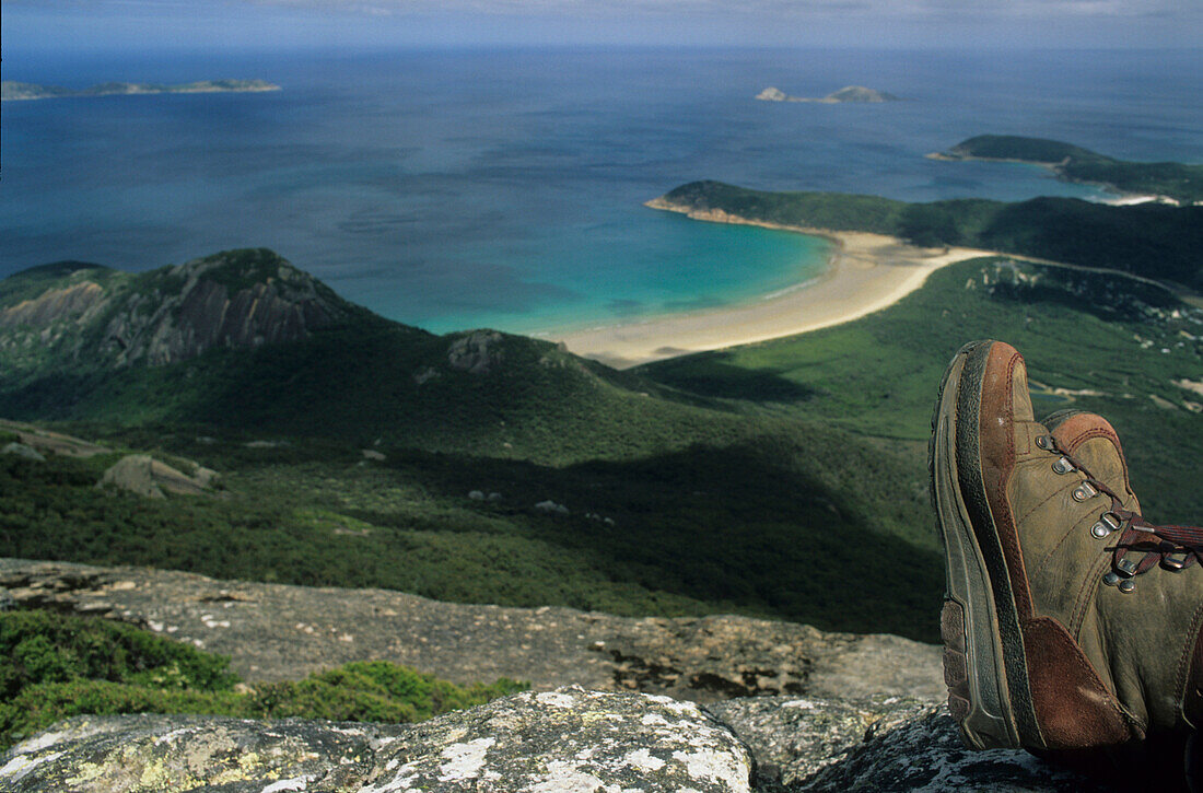 Hiking boots resting above coastal panorama from Mount Oberon on Wilsons Promontory, most southerly point of mainland Australia, Wilsons Promontory, Victoria, Australia