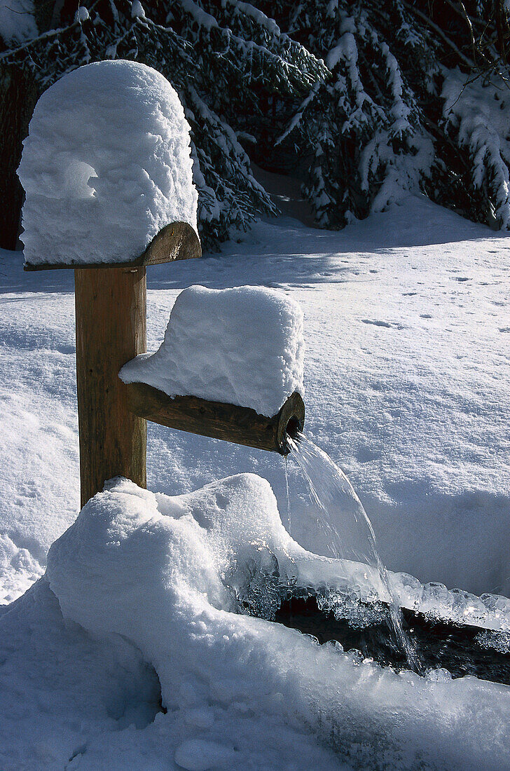 Snowy wooden well, winer landscape