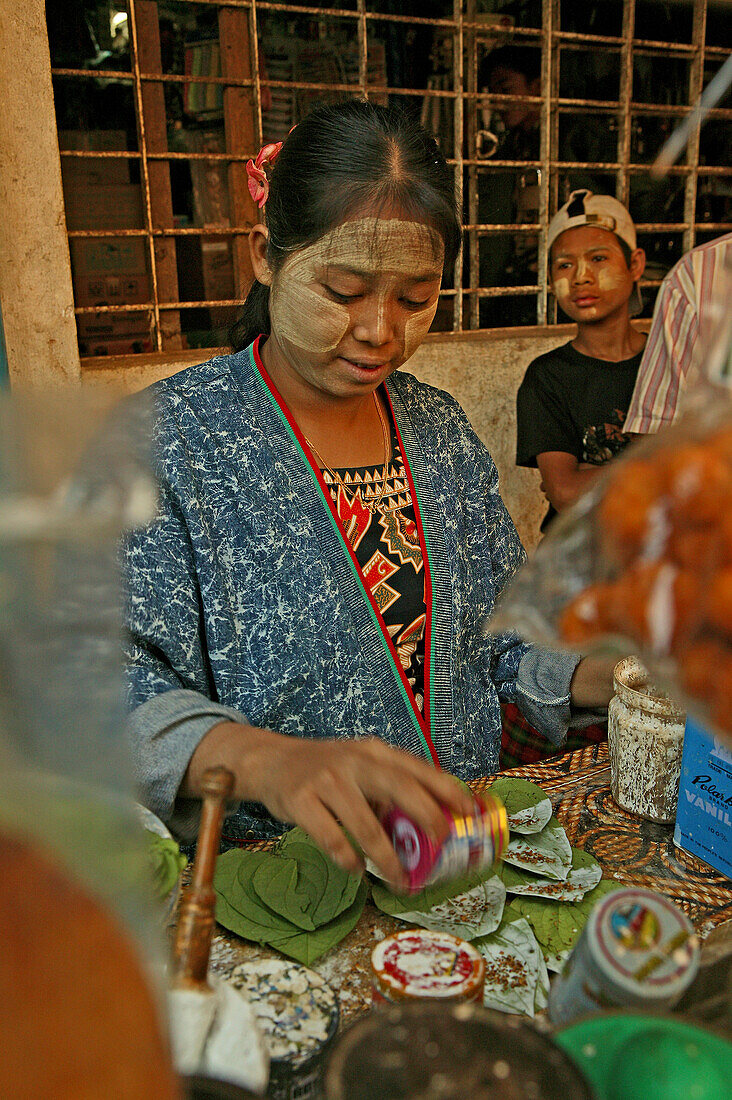Preparing betel at a stall, Bago market, Burmese woman prepares betel leaves with slaked lime, spices and areca palm nut to sell at Bago's market, Kun-Yar, Burmesische verkaueferin mit Betel