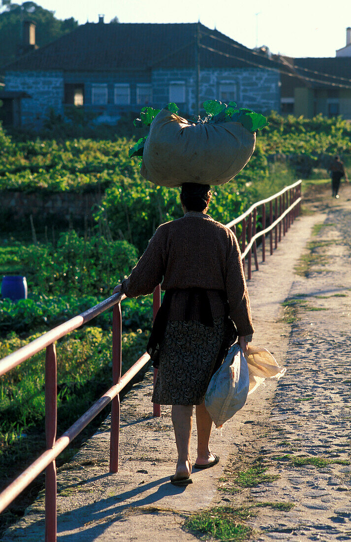 Countrywoman carrying load on head, Castelo do Naiva, Portugal