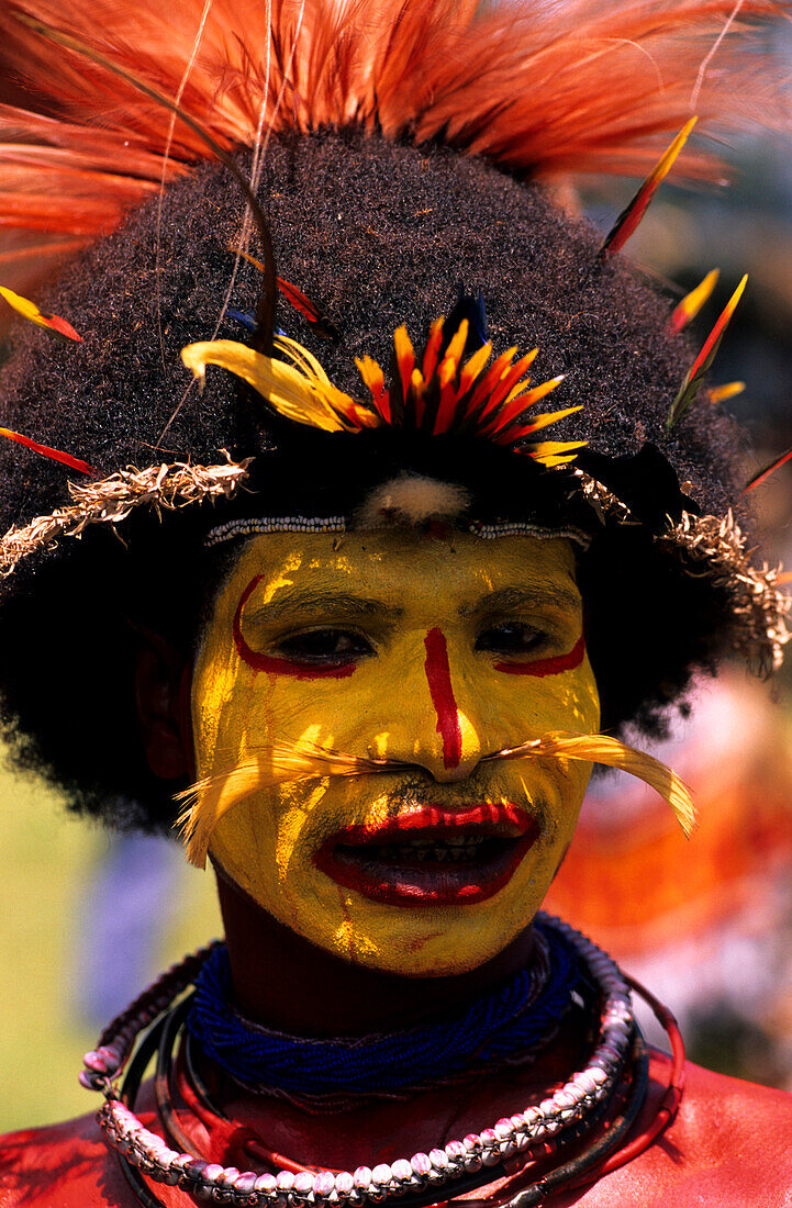 Local man with yellow painted face, Wigman, Portrait, Sing Sing festival, Mt Hagen, Eastern Highlands, Papua New Guinea, Melanesia
