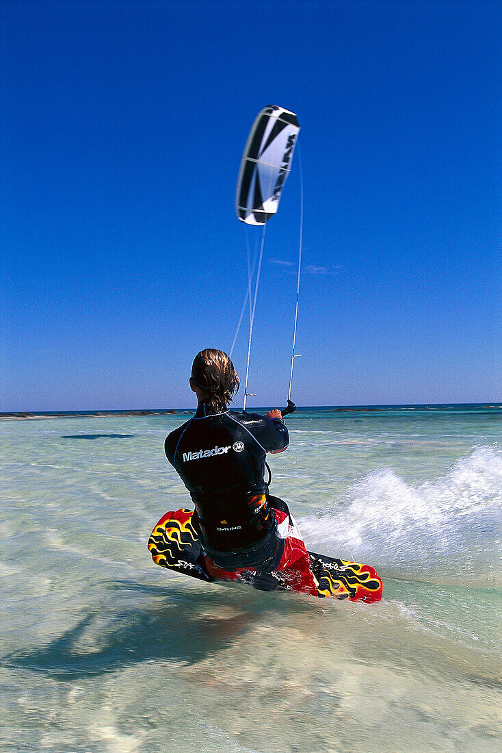 Kitesurfer with kite surfing the waves, Djerba, Tunesia