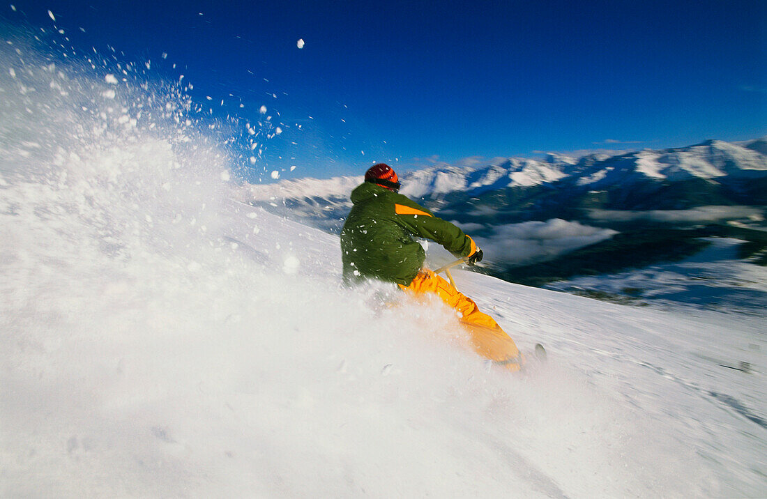 Young man snowscooting downhill, Serfaus, Tyrol, Austria