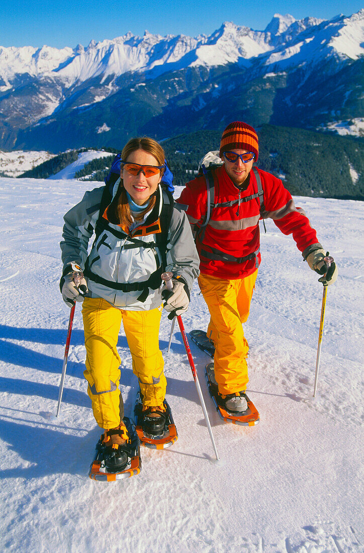 Young couple snowshoeing, Serfaus, Tyrol, Austria