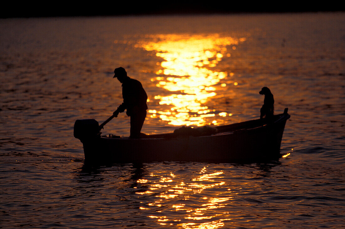 Fischer in einem Boot bei Sonnenuntergang, Marken, Italien, Europa