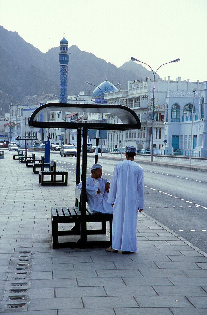 Men talking at a stop, Muscat, Oman