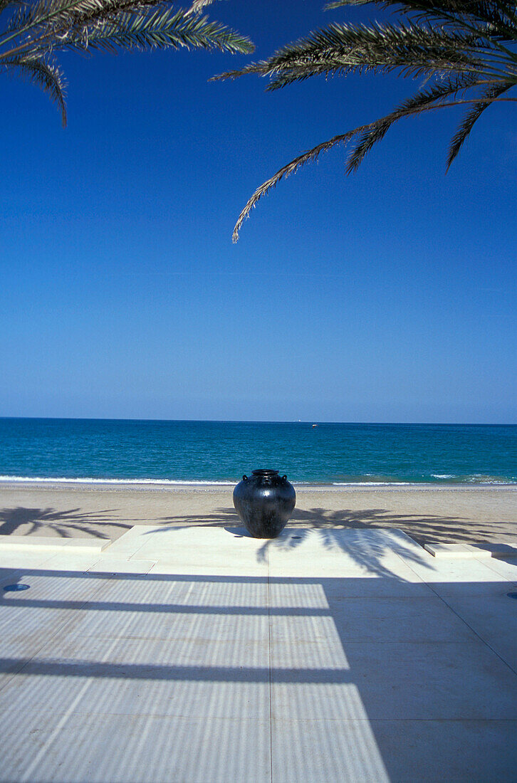 Sandy beach and ocean under blue sky, The Chedi Hotel, Muscat, Oman, Middle East, Asia