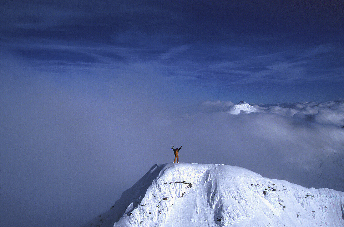 Alpinist on summit, Western Alps, The Alps, Europe