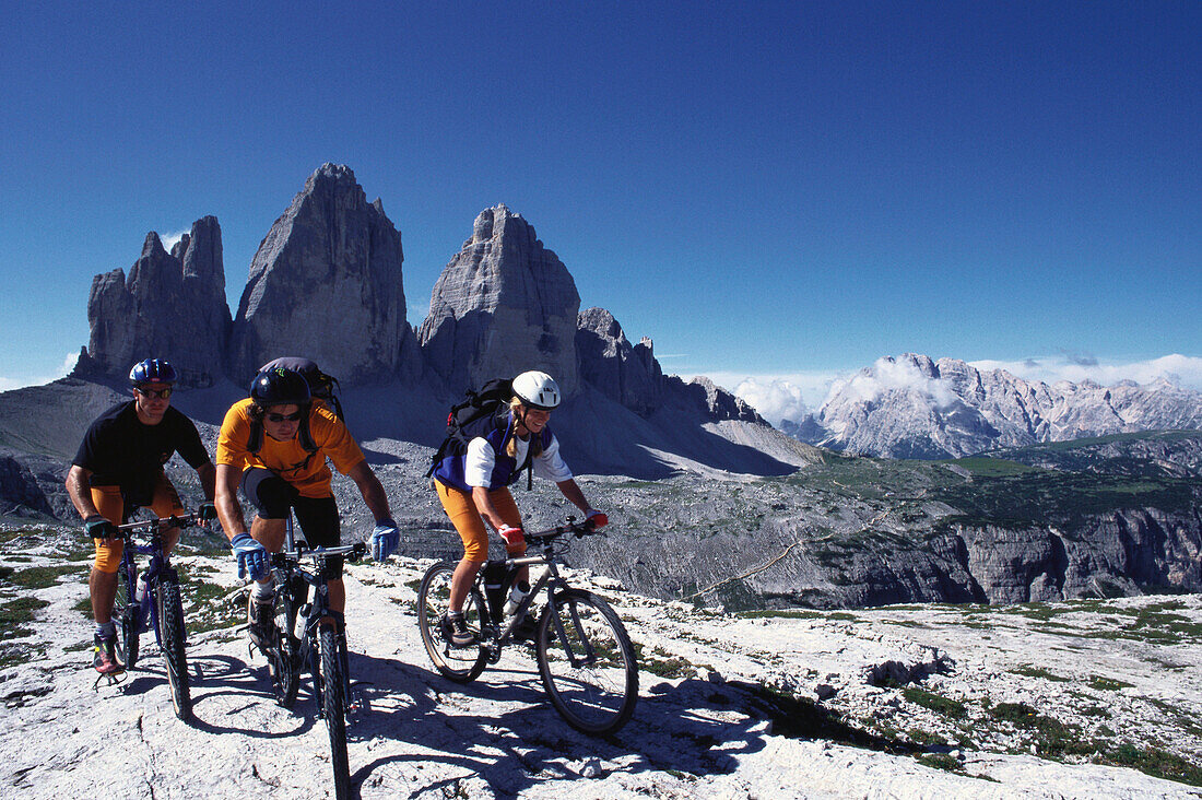 Mountainbiker im Gebirge unter blauem Himmel, Drei Zinnen, Südtirol, Italien, Europa