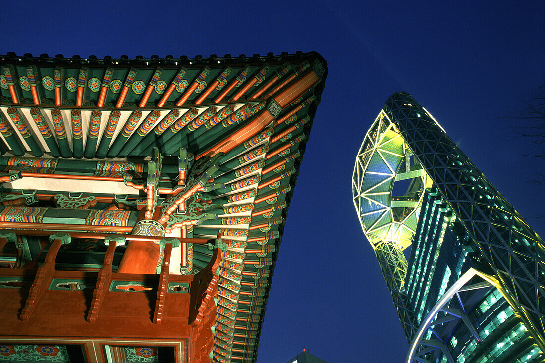 Temple roof next to modern high rise building at night, Millenium Plaza, Seoul, South Korea, Asia