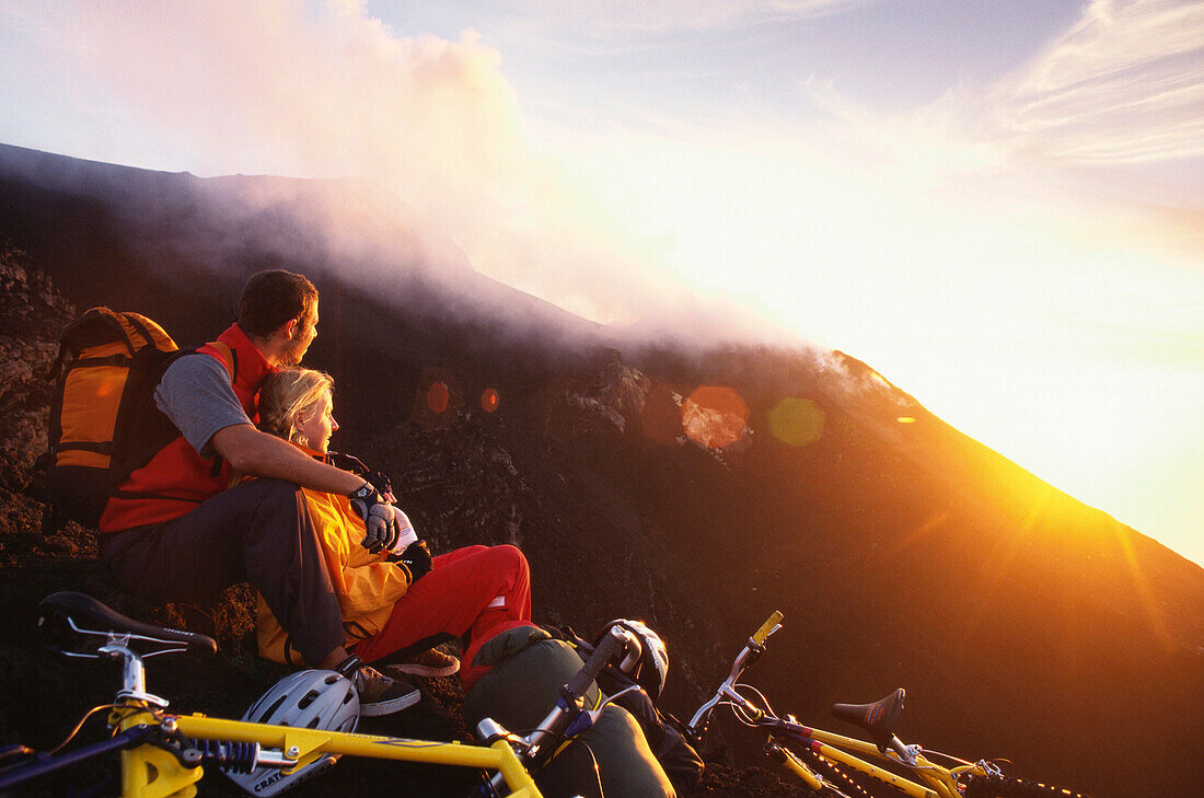 Mountain bikers on Vulcano island at sunset, Aeolian Islands, Sicily, Italy, Europe