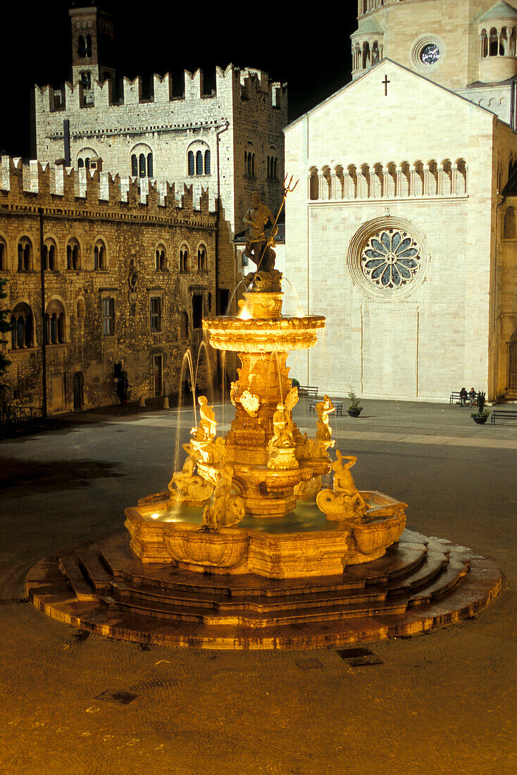 View at the illuminated fountain at square Piaza Duomo, Trento, Italy