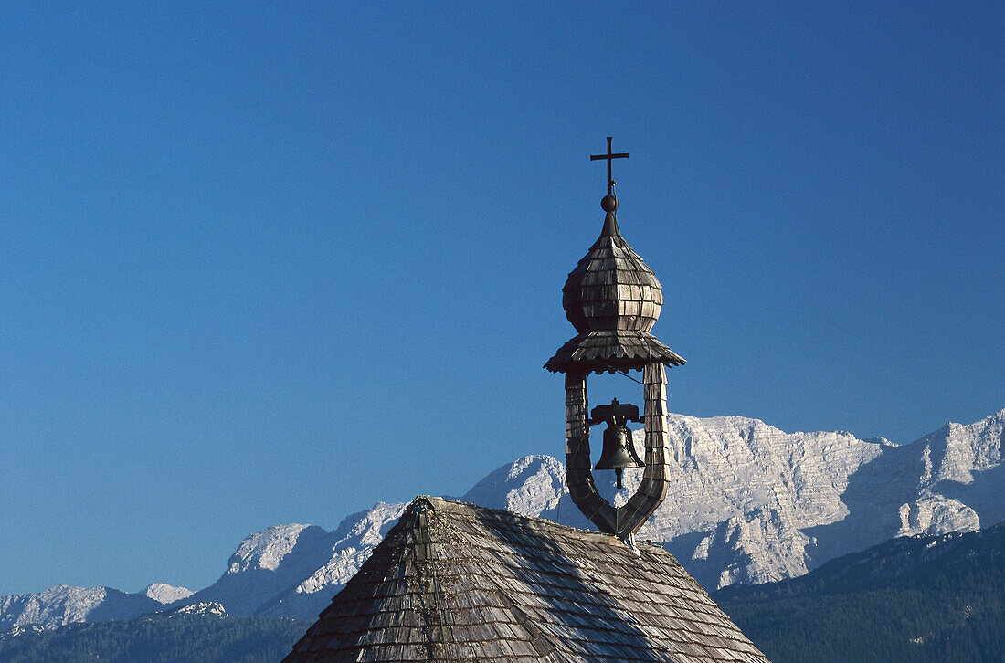 Chapel's tower and bell in front of mountains, Winkelmoosalp, Bavaria, Germany