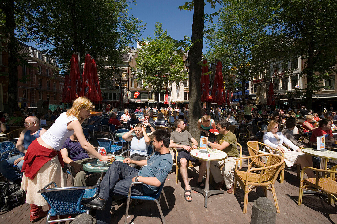 People, Sidewalk Cafe, Leidseplein, People sitting at open air cafes at Leidseplein at a sunny day, Amsterdam, Holland, Netherlands