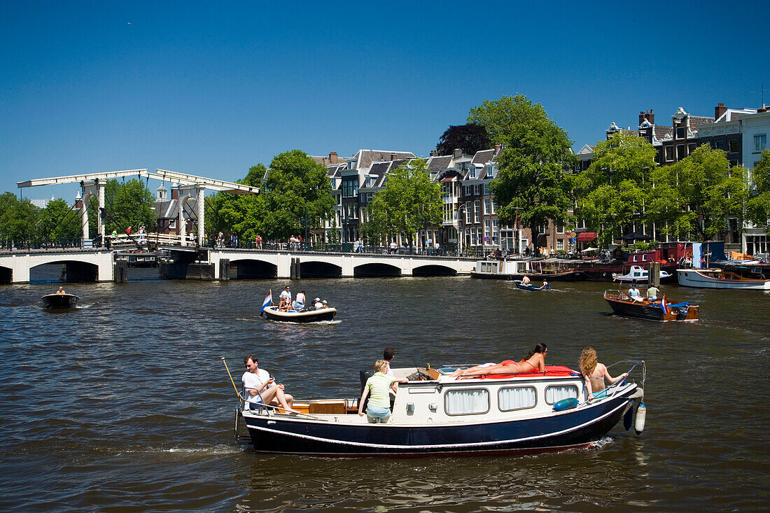 Leisure Boats, Magere Brug, Amstel, Leisure boats on Amstel on a sunny day, Magere Brug Skinny Bridge, in background, Amsterdam, Holland, Netherlands