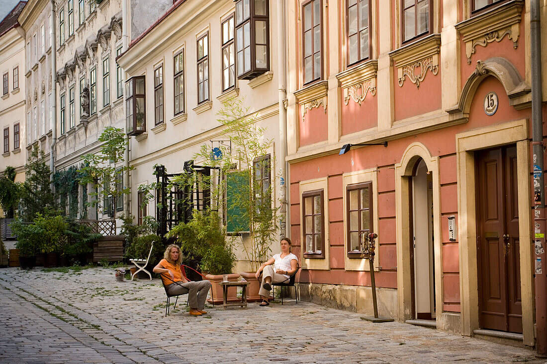 Two women sitting in front of a house, Spittelberg, Vienna, Austria