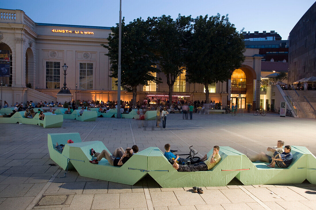 People sitting in a bar in front of Kunsthalle Wien at MuseumsQuartier in the evening, Vienna, Austria