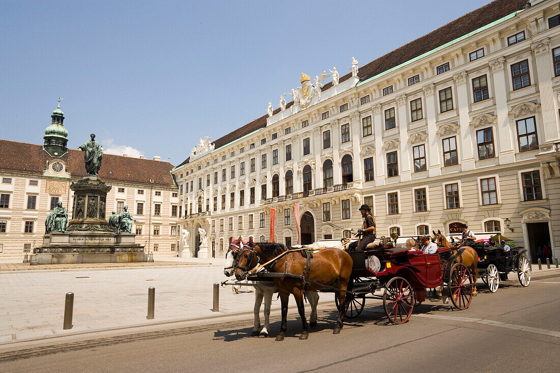 Fiaker passing Alte Hofburg during a city tour, Vienna, Austria