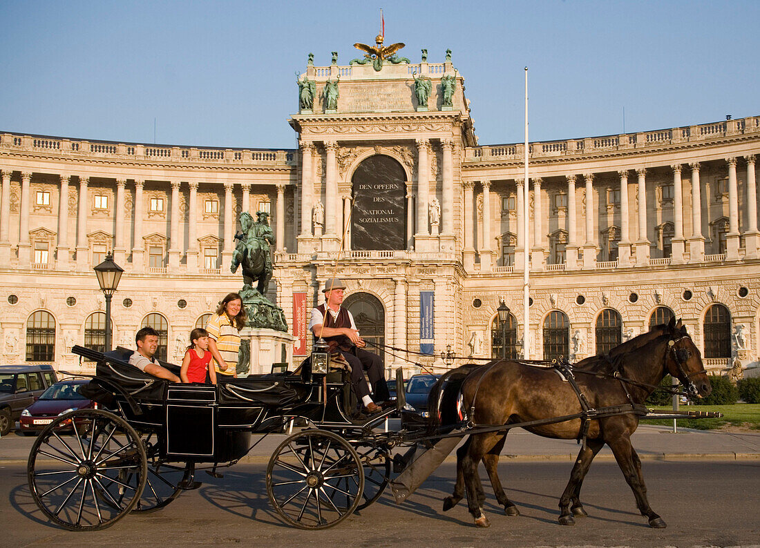 Fiaker passing the Neue Hofburg during a city tour, Vienna, Austria
