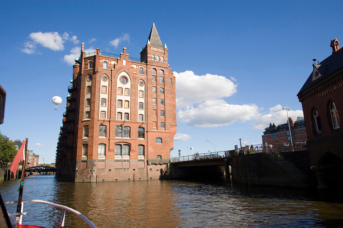 View from the bow of a ship at a brick-lined building of the Speicherstadt, Hamburg, Germany