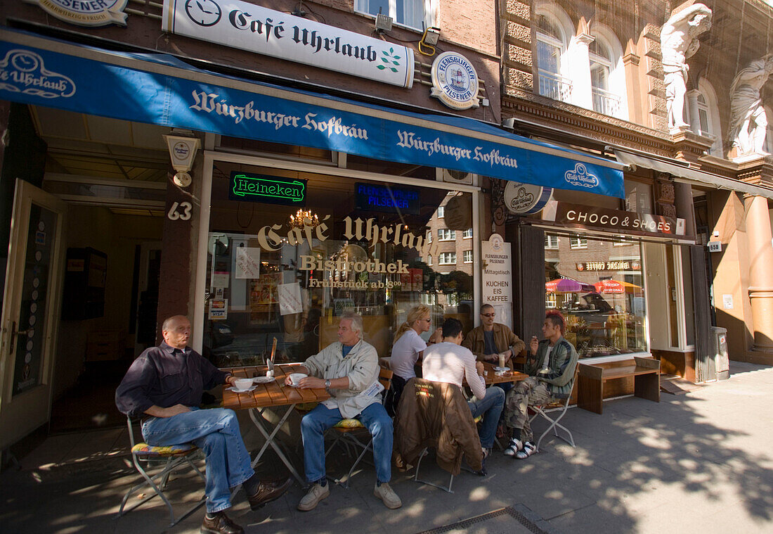 People sitting outside of Cafe Uhrlaub at St. Georg street, Hamburg, Germany